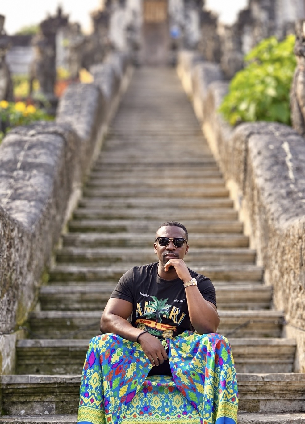 Koby seated on stone steps in Bali, Indonesia