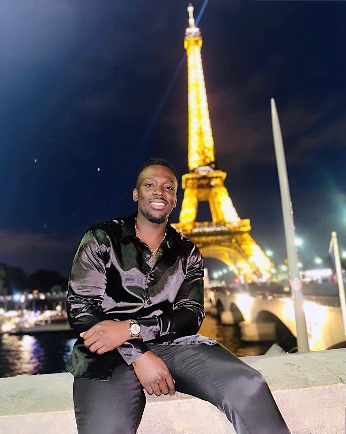 Koby near the illuminated Eiffel Tower in Paris, France