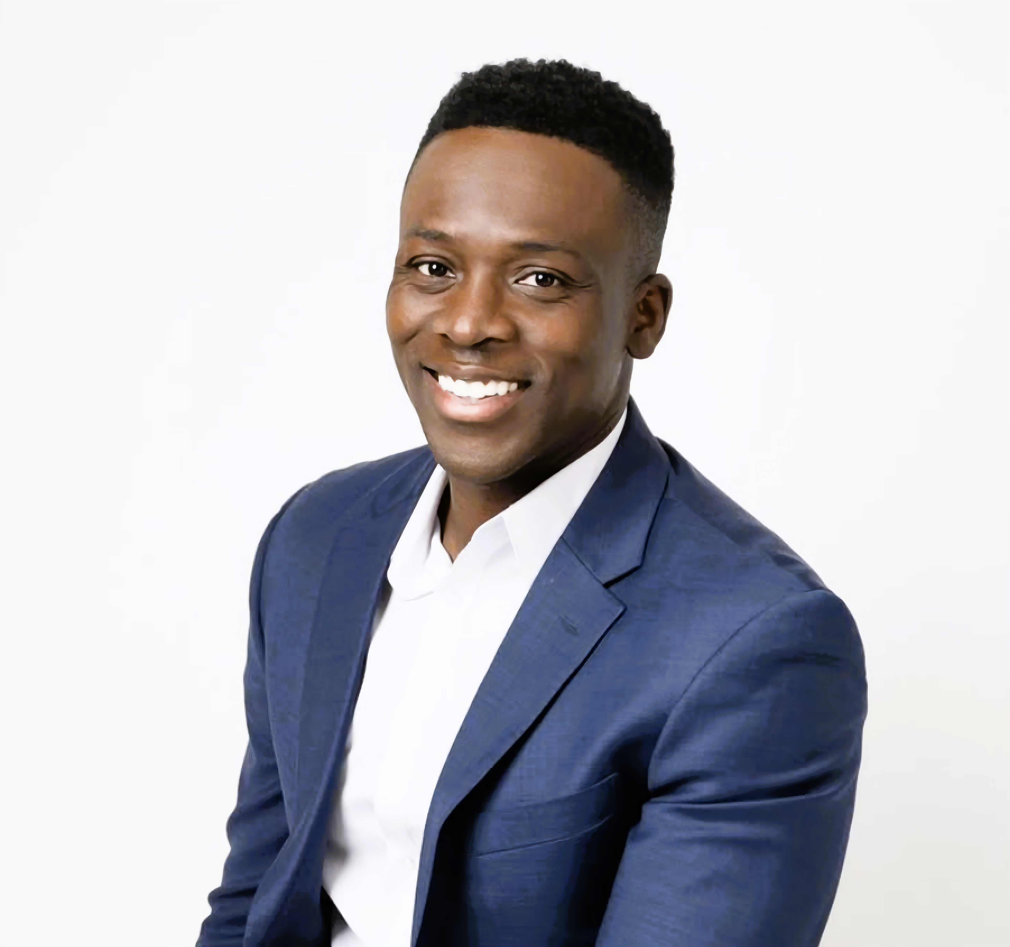 Koby Diaka wearing a navy blue suit and white shirt